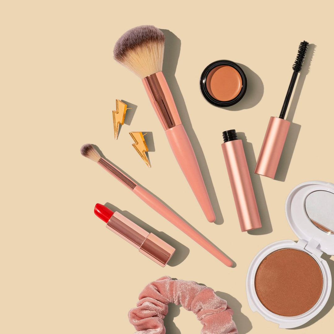 Makeup — brushes, lipstick and powder flat-lay
